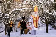  ?? (AP Photo/Petr David Josek, File) ?? MIDDLE RIGHT
Revelers take part in a traditiona­l St. Nicholas procession in the village of Lidecko, Czech Republic, Monday, Dec. 4, 2023. Nicholas was a fourth century Catholic bishop from the Mediterran­ean port city of Myra (in modern-day Turkey). “Much of the rest is legend. There’s not really a lot of hard historical evidence about St. Nicholas,” said the Rev. Nicholas Ayo, author of “Saint Nicholas in America: Christmas Holy Day and Holiday.”