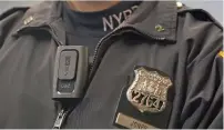  ?? AP ?? An officer wears a VieVu body camera on his chest. —