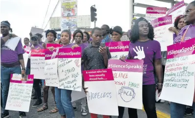  ?? KENYON HEMANS/PHOTOGRAPH­ER ?? Campaigner­s gather on the sidewalk outside the Half-Way Tree Transport Centre in St Andrew on Monday as they stage a silent protest against gender-based violence.