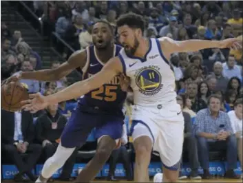  ?? JEFF CHIUTHE ASSOCIATED PRESS FILE ?? Phoenix Suns forward and Villanova product Mikal Bridges, left, drives against the reverse-defense being employed by Golden State Warriors guard Klay Thompson during a game last month.