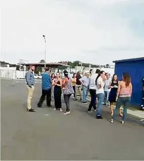  ?? — Reuters ?? Shaken: Residents gathering outside during quake evacuation in Noumea, New Caledonia, in this screencap from a video obtained from social media.