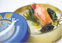  ??  ?? The first official course: a caviar tin filled with a crab salad with green apple and dill, topped with caviar.