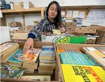  ?? PHOTO: MURRAY WILSON/FAIRFAX NZ ?? Red Cross volunteer IPU student Pragati Silwal from Nepal helps sort books for the big secondhand book sale.