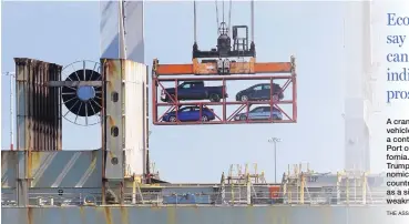  ?? THE ASSOCIATED PRESS ?? A crane transporti­ng vehicles operates on a container ship at the Port of Oakland in California. President Donald Trump and his economic advisers see the country’s trade deficits as a sign of economic weakness.