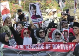  ?? DITA ALANGKARA, THE ASSOCIATED PRESS ?? Muslim protesters display a defaced poster of Burmese leader San Suu Kyi in Jakarta last Friday. Suu Kyi’s response to the plight of the Rohingya in Burma has disappoint­ed many.