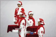  ?? ANDY WONG / AP ?? Chinese attendants rehearse the award ceremony of the men’s 500-meters race during a test event for the
2022 Beijing Winter Olympics at the National Speed Skating Oval in Beijing on Wednesday.