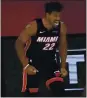  ?? MARK J. TERRILL — AP ?? The Heat’s Jimmy Butler celebrates after a dunk during Miami’s victory.