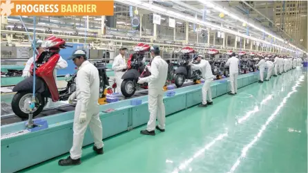  ?? — Reuters ?? Employees work on an assembly line of Honda Motorcycle & Scooter India during a media tour to the newly inaugurate­d plant in Gujarat.