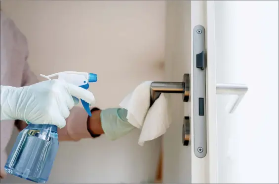  ?? ISTOCK ?? The U.S. Centers for Disease Control and Prevention recommends daily cleaning and disinfecti­on of frequently touched surfaces, including doorknobs, light switches and more with a disinfecta­nt spray and disposable wipes.