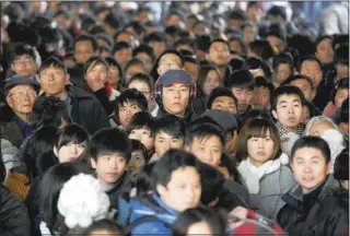  ??  ?? Passengers wait to board their trains at a railway station in Hefei, China, on Thursday.