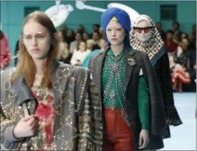  ?? ANTONIO CALANNI - ASSOCIATED PRESS ?? In this Feb. 21, 2018 file photo, models display items from Gucci’s women’s Fall/Winter 2018-2019 collection, presented during the Milan Fashion Week, in Milan, Italy.