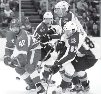  ??  ?? Red Wings forward Henrik Zetterberg clears the puck away from Avalanche forward Matt Nieto (83) during Saturday’s game at Joe Louis Arena in Detroit. Paul Sancya, The Associated Press