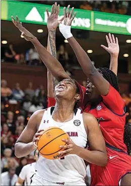  ?? MIC SMITH / AP ?? South Carolina’s Aliyah Boston (4) fights through the defense of Mississipp­i’s Rita Igbokwe (32) in the the SEC tournament in Greenville, S.C. on Saturday.