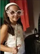  ?? ASSOCIATED PRESS ?? This August 2018 photo provided by Selah Hovda shows a guest at her son’s Harry Potter-themed birthday party holding a homemade wand and Luna Lovegood glasses in Phoenix, Ariz. For the party Hovda made paper versions of Lovegood’s glasses and wands of wooden rods decorated with hot glue and paint.