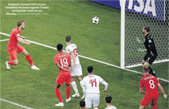  ?? / NICOLAS ASFOURI / AFP ?? England's forward Harry Kane completes his brace against Tunisia during their clash on, on Monday.