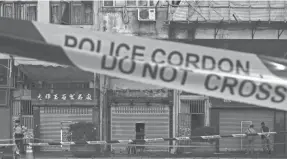  ?? VINCENT YU/AP ?? The site of Sunday night’s deadly apartment fire is taped off Monday in Hong Kong. The fire highlights lingering safety issues in older buildings.