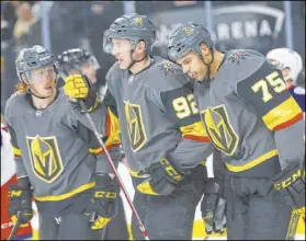  ??  ?? Dejected Knights right wing Ryan Reaves (75) with teammates Cody Eakin, left, and Tomas Nosek after Reaves’ shot was blocked.