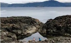  ?? ?? ‘There’s so much to learn here’ … Haley and Samantha Garvie play on rocks at SG ang Gwaay in British Columbia, Canada.