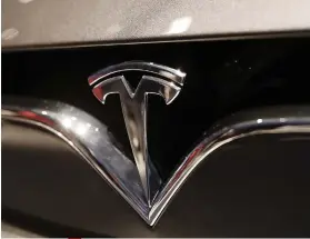  ??  ?? THE TESLA EMBLEM at the Auto show in Paris last October 2018.