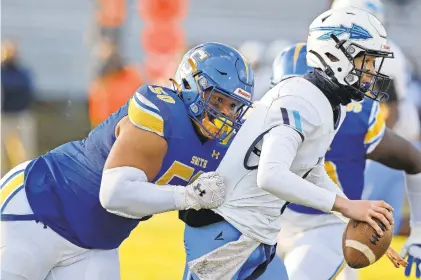  ?? JONATHON GRUENKE/STAFF ?? Oscar Smith’s Caleb Jones tackles Indian River’s Tyler Allison on Friday night in Chesapeake. Jones will lead the Tigers into a Class 6 Region A semifinal tonight against Grassfield.