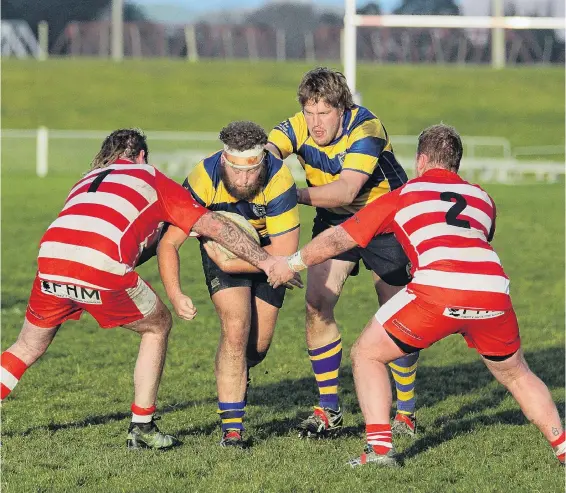  ?? PHOTO: SI LEEDS ?? On the charge . . . Toko prop James Agnew is given a little help from teammate Matt Lyon as they try to break the tackle from Daniel Miller and Josh Turnbull in a match at Balclutha on Saturday.