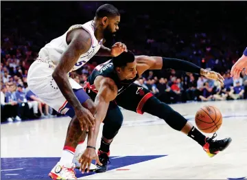  ?? AP PHOTO BY CHRIS SZAGOLA ?? Miami Heat's Hassan Whiteside, right, reaches for the ball while Philadelph­ia 76ers' Amir Johnson, left, defends during the first half in Game 1 of a first-round NBA basketball playoff series Saturday, April 14, in Philadelph­ia.