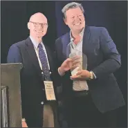  ??  ?? Arkansas Democrat-Gazette publisher Walter E. Hussman Jr. (left) accepts the Mega-Innovation Award from Dave Kennedy, the chief revenue officer for the Honolulu Star-Advertiser. The Democrat-Gazette was honored for its iPad initiative at the Key Executives Mega-Conference in Fort Worth, Texas, on Tuesday. (Arkansas Democrat-Gazette/Barry Arthur)