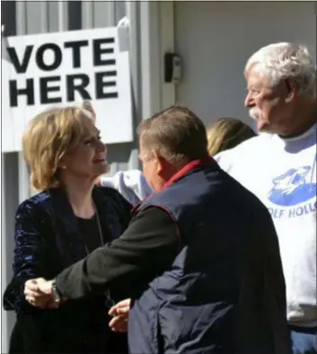  ?? DONNA CAMPBELL/THE DAILY LEADER VIA AP ?? Appointed Republican U.S. Sen. Cindy Hyde-Smith, center, greets neighbors at her Brookhaven, Miss., precinct after voting Tuesday, Nov. 27, in her runoff race against Democrat Mike Espy.