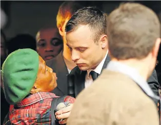  ?? Picture: REUTERS ?? COMFORT OF STRANGERS: A supporter has a quick word with Oscar Pistorius outside court