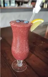  ??  ?? THICK LIKE A SMOOTHIE: The blueberry daiquiri mocktail at Tash’s Craft Bar