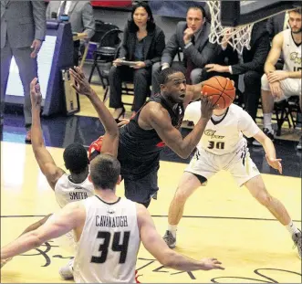  ?? DAVID JABLONSKI / STAFF ?? Dayton’s Kendall Pollard is fouled as he shoots against George Washington’s Collin Smith. Pollard led the Flyers with 24 points, but UD couldn’t climb back from an early 15-point deficit.