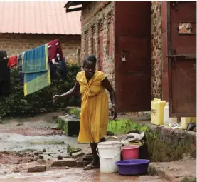  ?? ?? Barbara Nabulo cleans clothes at her home in Busamaga-Mutukula village in Mbale, Uganda, Thursday, April 25, 2024. There can be lifelong challenges for people with sickle cell disease in rural Uganda, where it remains poorly understood. (AP Photo/Hajarah Nalwadda)