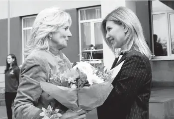  ?? SUSAN WALSH/AP ?? First lady Jill Biden visits Olena Zelenska, wife of Volodymyr Zelenskyy, outside a school Sunday in Uzhhorod.