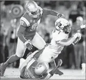  ??  ?? UCLA’S KENNY CHURCHWELL tackles Colorado’s Jaren Mangham as Odua Isibor approaches.