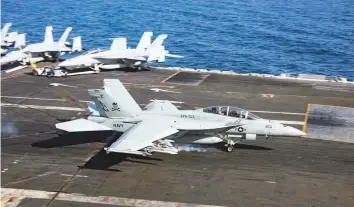  ?? Reuters ?? An F/A-18F Super Hornet makes an arrested landing on the aircraft carrier USS Abraham Lincoln in the Gulf of Oman on Wednesday.