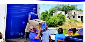  ??  ?? Chef Steve Sowa, caught unloading one of the many boxes that were packed with various items for the Refuge of Hope Center recently