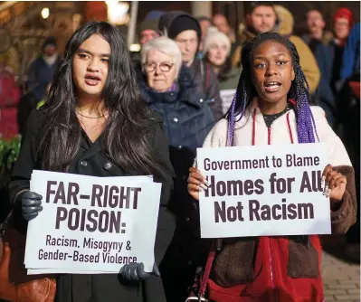  ?? ?? Defiance: Protesters holding placards and singing at the demo in Ashtown, Dublin, last night