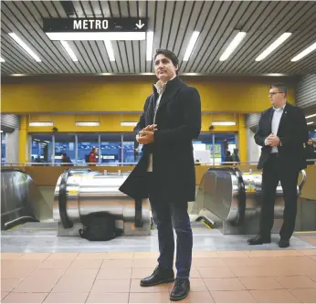  ?? SEAN KILPATRICK / THE CANADIAN PRESS ?? Prime Minister Justin Trudeau, seen here Tuesday waiting to greet commuters at a metro station in Montreal, got stronger as crowds got bigger in the final week of the campaign, John Ivison writes.