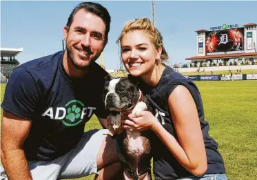  ?? Gerardo Mora / Getty Images ?? Astros star Justin Verlander and his wife, Kate Upton, merged their two passions to create a program — Adopt. Rescue. Heal. — that trains rescue dogs to become service animals for veterans with PTSD.