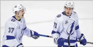  ?? AP PHOTO ?? Tampa Bay Lightning’s Anthony Cirelli, right, celebrates with Yanni Gourde after scoring his first-period goal against the Boston Bruins during NHL playoff action Wednesday night in Boston.