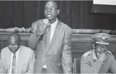  ??  ?? Bulawayo Town Clerk Mr Christophe­r Dube (centre) addresses the public and stakeholde­rs during the city council’s Public Transport Policy pre-launch at the small city hall yesterday flanked by the Mayor, Councillor Martin Moyo (left) and the ZRP Officer...