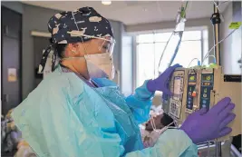  ??  ?? BELOW, LEFT: Morgan checks on COVID-19 patient Christophe­r Martinez on Thursday.