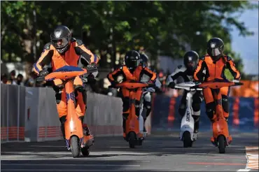  ?? PHOTOS BY VALERIO PENNICINO — GETTY IMAGES ?? French rider Aymard Vernay, left, competes during the eSC eSkootr Championsh­ip in Sion, Switzerlan­d, in May 2022.