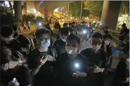  ?? KIN CHEUNG — THE ASSOCIATED PRESS FILE ?? People hold LED candles on June 4, 2021 to mark the anniversar­y of the military crackdown on a pro-democracy student movement in Beijing, outside Victoria Park in Hong Kong.