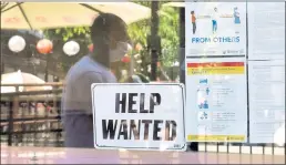  ?? FREDERIC J. BROWN — AFP/GETTY IMAGES/TNS ?? As the economy reopens, restaurant­s and other businesses are putting out “help wanted” signs and jobless claims are falling.