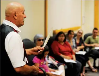  ?? CLIFFORD SKARSTEDT Examiner ?? Curve Lake First Nation’s Merritt Taylor gives Ministry of Natural Resources staff an introducti­on to the Ojibwe language as part of National Aboriginal Day on Thursday at the Robinson Place building on Water St.
