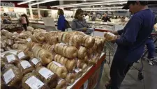  ??  ?? STOCKING UP: Food prices, including bagels at Costco in Mountain View, Calif., have fallen in the coronaviru­s crisis, which offset an increase in energy prices.