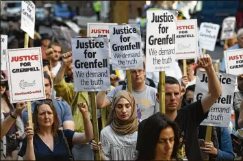  ?? CARL COURT / GETTY IMAGES ?? Protesters attend a rally Friday outside government offices in London calling for justice for those affected by Wednesday’s Grenfell Tower fire. Thirty people are confirmed dead and about 70 are missing after the fire.