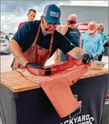  ?? COURTESY OF BACKYARD PITMASTERS ?? An instructor teaches a Backyard Pitmasters class. Classes will focus on everything from brisket to chicken, turkey and pork, with tips on how to rub, smoke and serve.