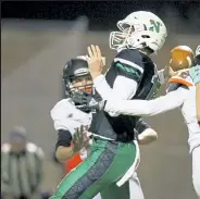  ?? Timothy Hurst / Staff Photograph­er ?? Niwot quarterbac­k Ayden Bartko attempts a pass Thursday night against Lewis-palmer.